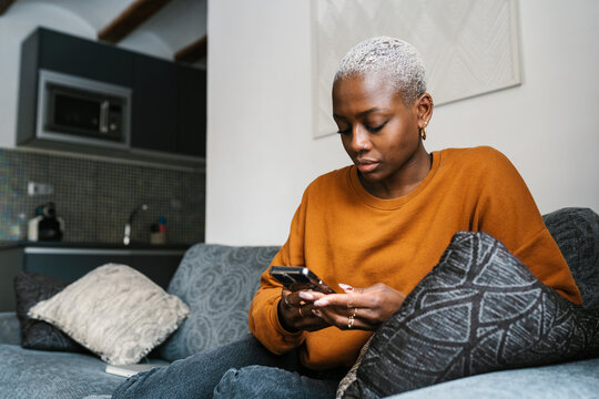 Serious Woman Reading Text Message On Smartphone