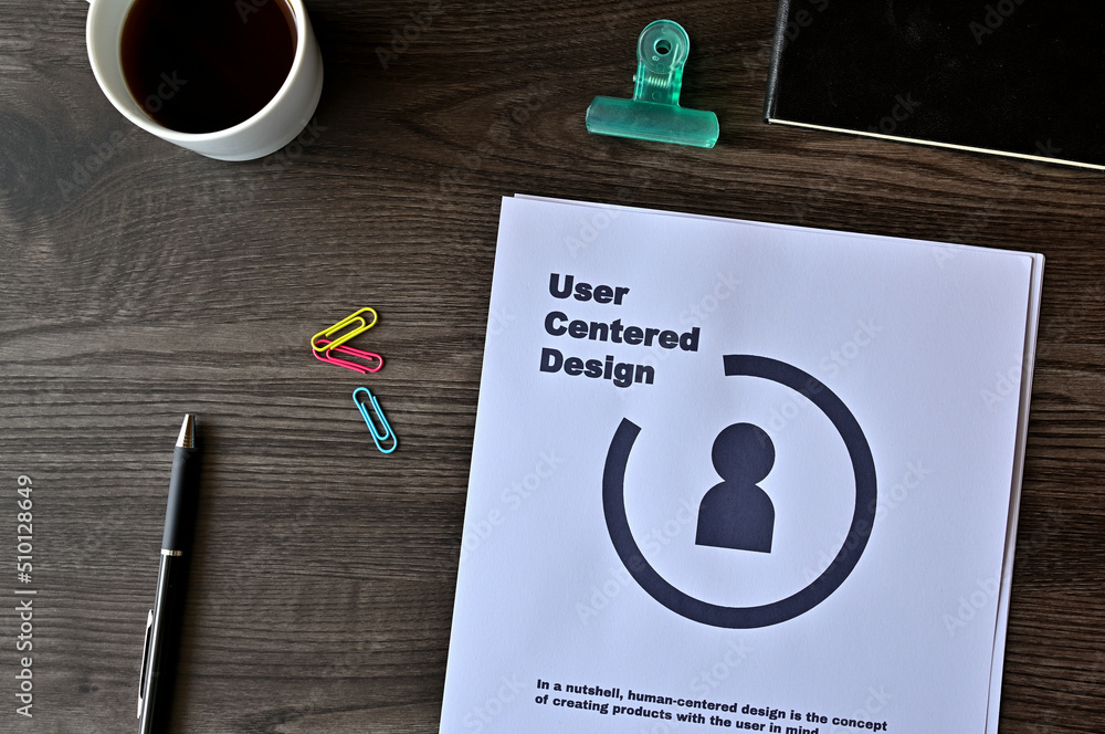 Aufkleber there is dummy documents that created for the photo shoot on the desk about user centered design.