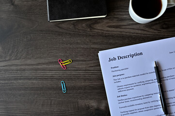 There is dummy documents that created for the photo shoot on the desk about Job Description.