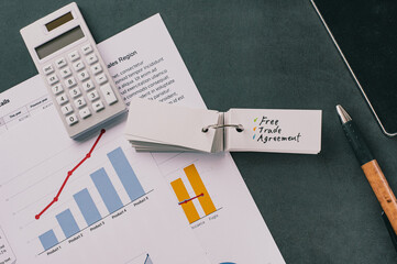 There is word card on the desk about free trade agreement. It's placed with dummy documents.