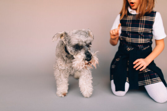 Girl telling dog to stay. 