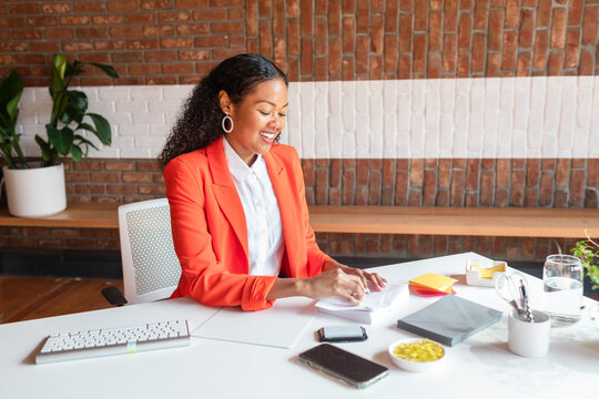 Cheerful event planner on blazer at front desk