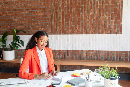 Businesswoman preparing invitations at  cowork space