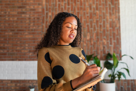 Applied woman taking notes in office