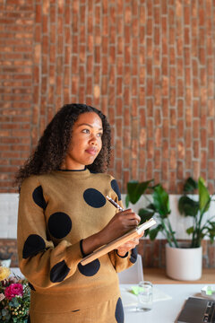 Female taking notes at work