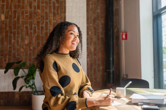 Successful elegant businesswoman happily in office