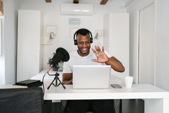 Happy black blogger greeting audience