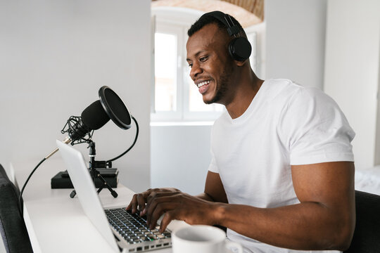 African American blogger using laptop