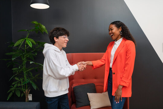 Teenage boy shaking hands with his didactic counselor