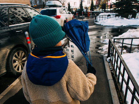 A boy is walking home from school.