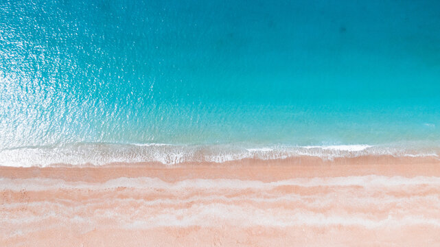 aerial photo of a sandy beach with azure water