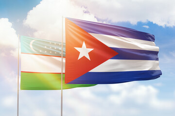 Sunny blue sky and flags of cuba and uzbekistan