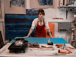 A women proudly stands in front of her business