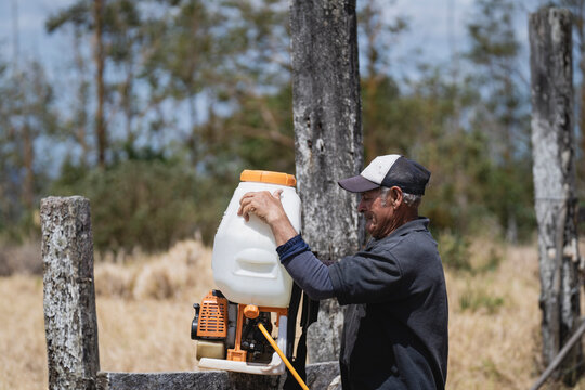 Old man checking a fumigation pump