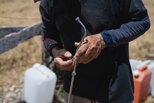 Hands of a man repairing a sprayer of a fumigation pump. 