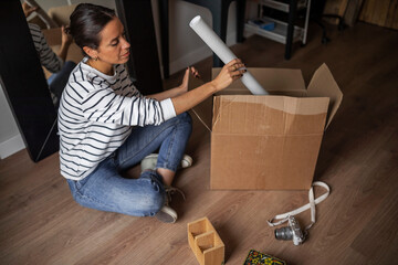 Young woman with a moving box at home