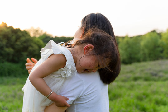 crying child on mother's shoulder