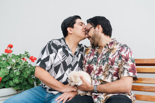 Man kissing boyfriend on his forehead