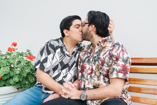 Gay couple kissing tenderly on the lips