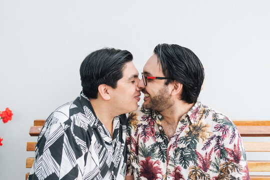 Gay couple laughing mid kiss