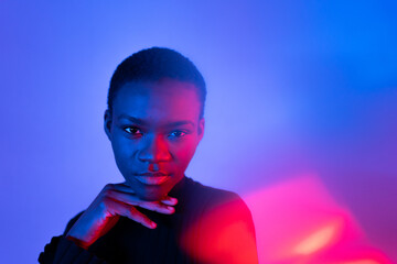 Portrait Of A Woman Showing Her Hands Under Coloured Gel Lights.