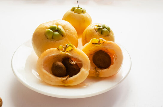 Whole And Halves Rose Apples With Seeds In A White Plate 