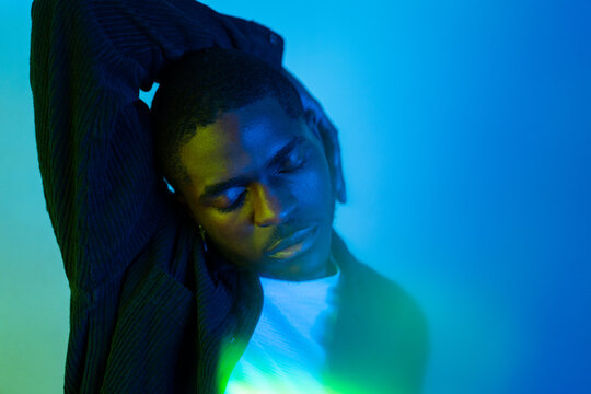 Blueish Portrait Of A  Man Under Coloured Gel Lights. 