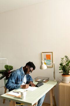 Cool black man working at office desk