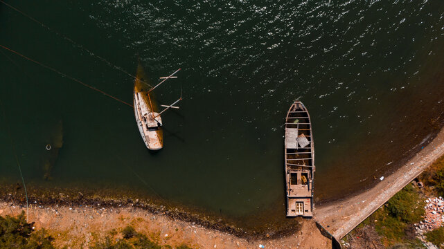 drone photo of two sunken ships near the coast