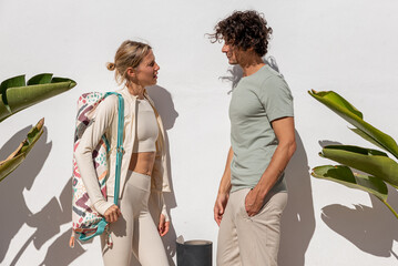 Happy friends talking on street before yoga