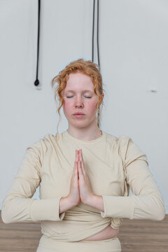 Woman meditating with prayer hands