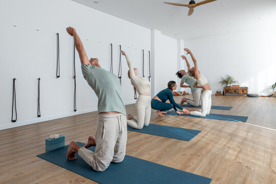 People doing Supported Camel pose variation