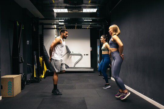 Personal trainer at the gym - Powered by Adobe
