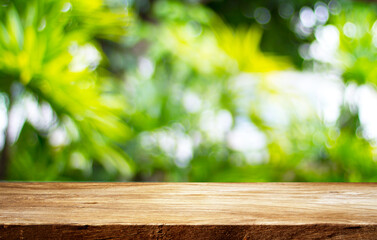 Closeup top wood table with nature green blur background, for your photo montage or product display, Space for placing items on the table.