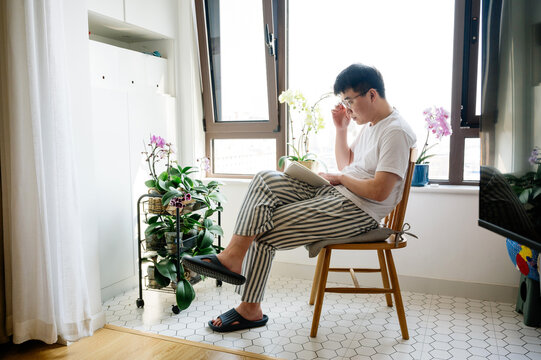 Young man reading at home
