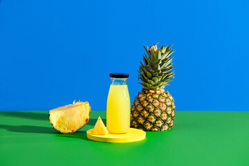 Delicious pineapple juice and fresh fruit on color background
