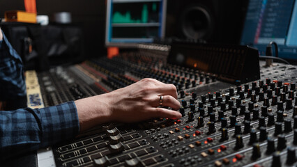 Anonymous Man Working With The Musical Equipment In The Studio