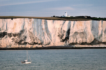 Yacht passing along the White cliffs of Dover in the English Channel east of Dover below South...