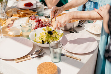 Female hands mixing sald during lunch