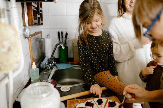 
grandma teaches her granddaughters to cook