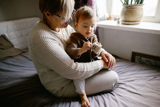 
woman with granddaughter at the window
