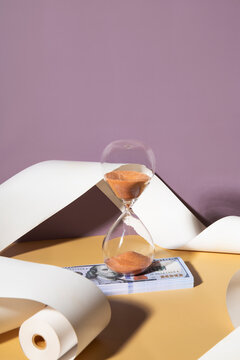 Hourglass on a pile of dollars