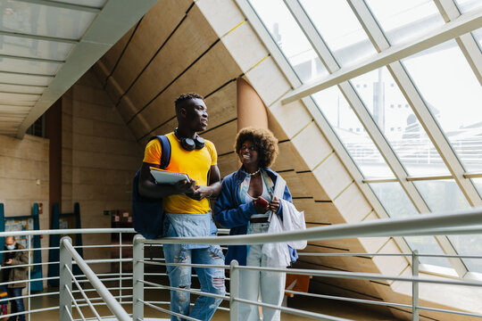 Couple in university walking in staircase