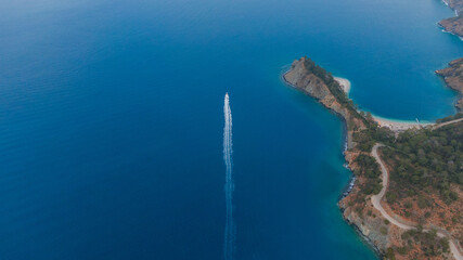 Fototapeta premium drone view of a fast speedboat in blue water