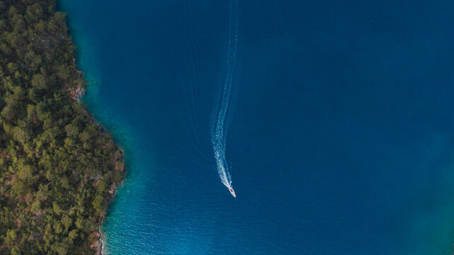 drone view of a fast speedboat in azure water