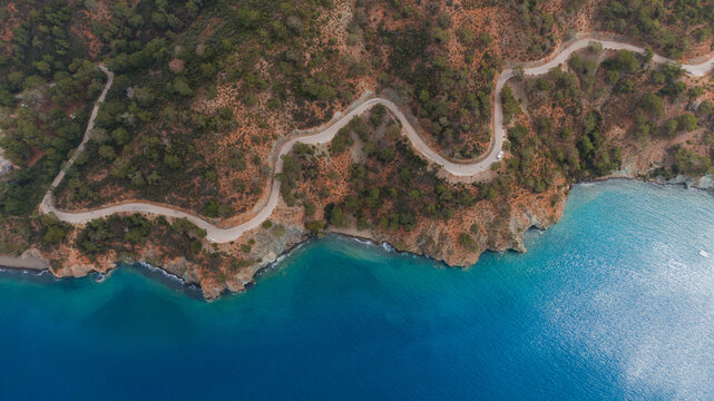 empty switchback road along the seacoast, drone view