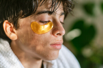 Teen boy with under eyes patches mask