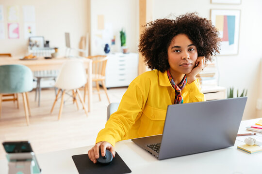 Black woman with laptop in creative workplace