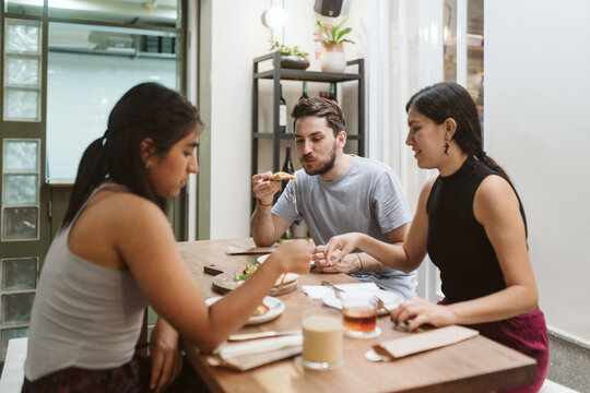 Multi-ethnic friends eating lunch