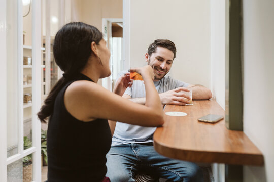 Two friends having drinks at a coffee shop